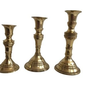 3 Brass Matching Candlesticks India. Size 7"x 3 1/2", 6" x 3 1/2", 5" x 2 1/4".